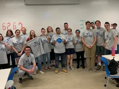 A group of many students at engineering plus camp wearing similar t-shirts