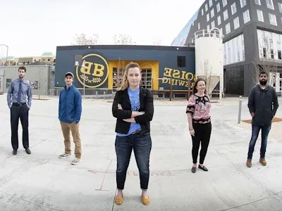 5 computer science students standing in front of the Boise Brewing building